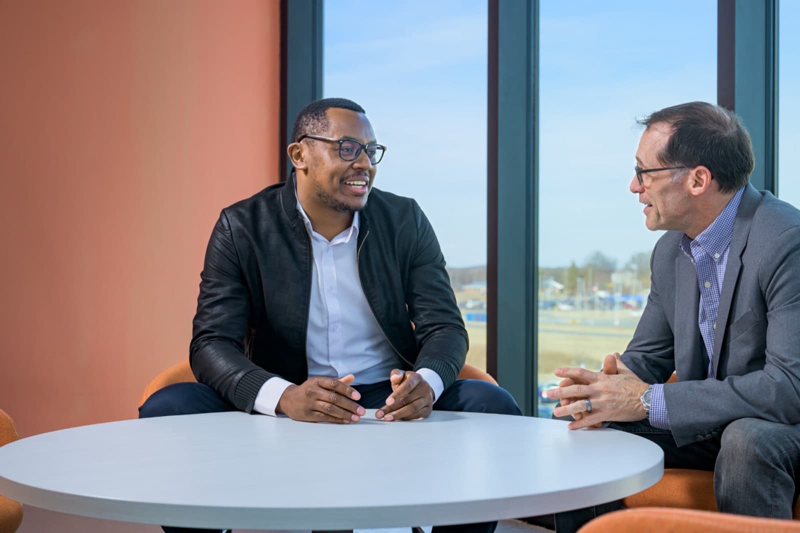 Morris Kithinji in conversation across a table